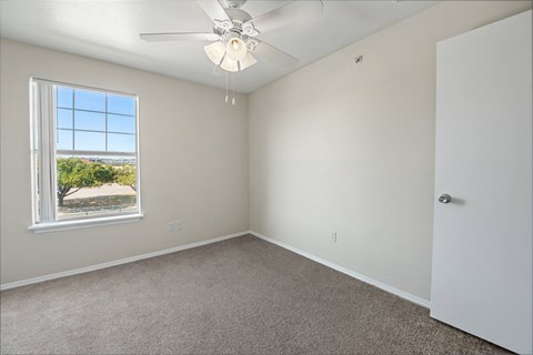 a bedroom with a ceiling fan and a window  at Collective on Riverside, Austin, 78741